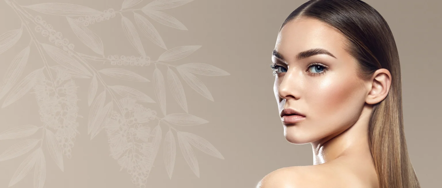 Desktop banner featuring a woman with sleek, straight hair and luminous skin, posed against a neutral beige background with subtle botanical illustrations.