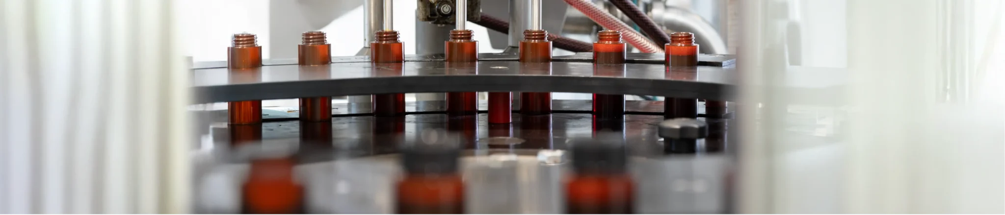 Bottles moving on an automated production line during filling process