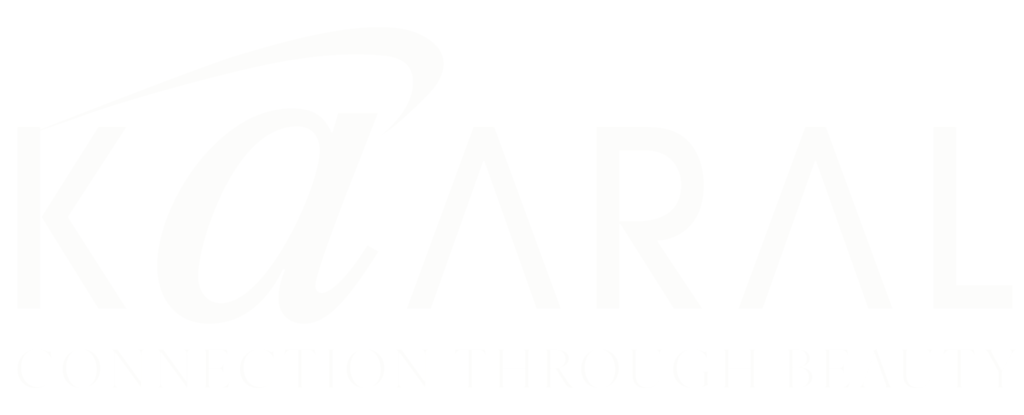 White Kaaral logo with stylized lowercase “a” and the text “CONNECTION THROUGH BEAUTY” on a transparent background.